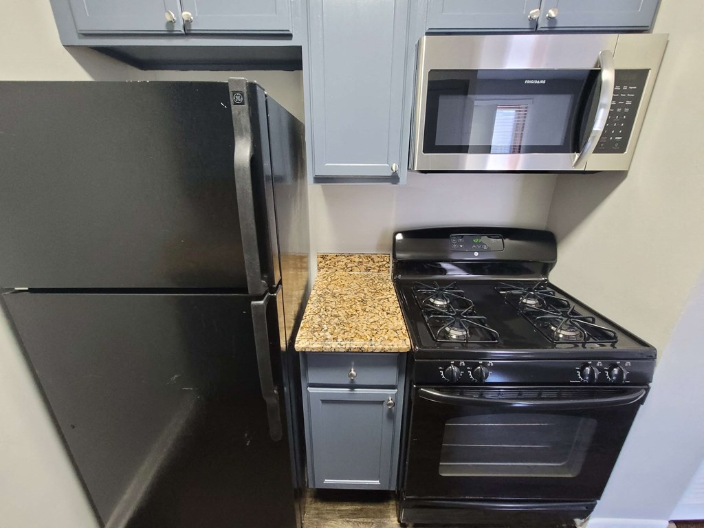 a kitchen with a stove microwave and refrigerator