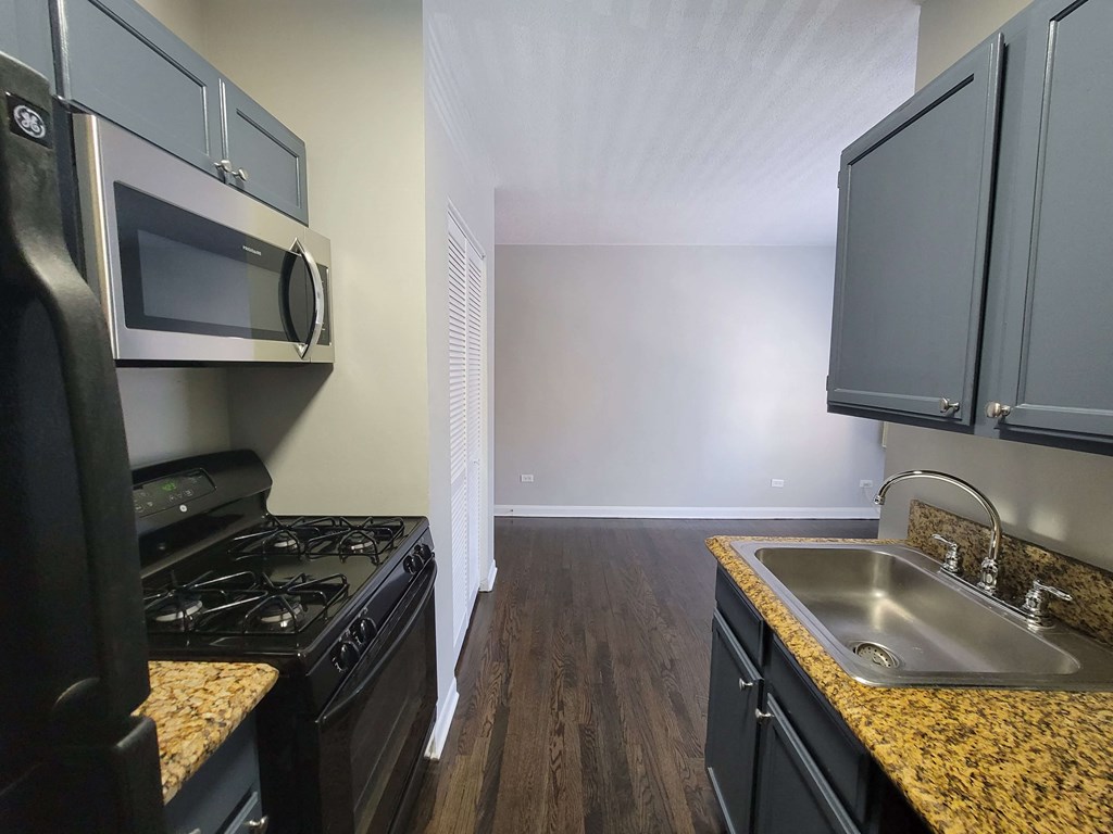 a kitchen with black appliances and granite counter tops