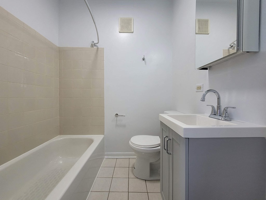 a bathroom with a sink toilet and a bath tub