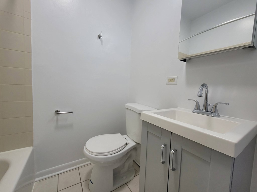 a bathroom with a toilet and a sink and a shower