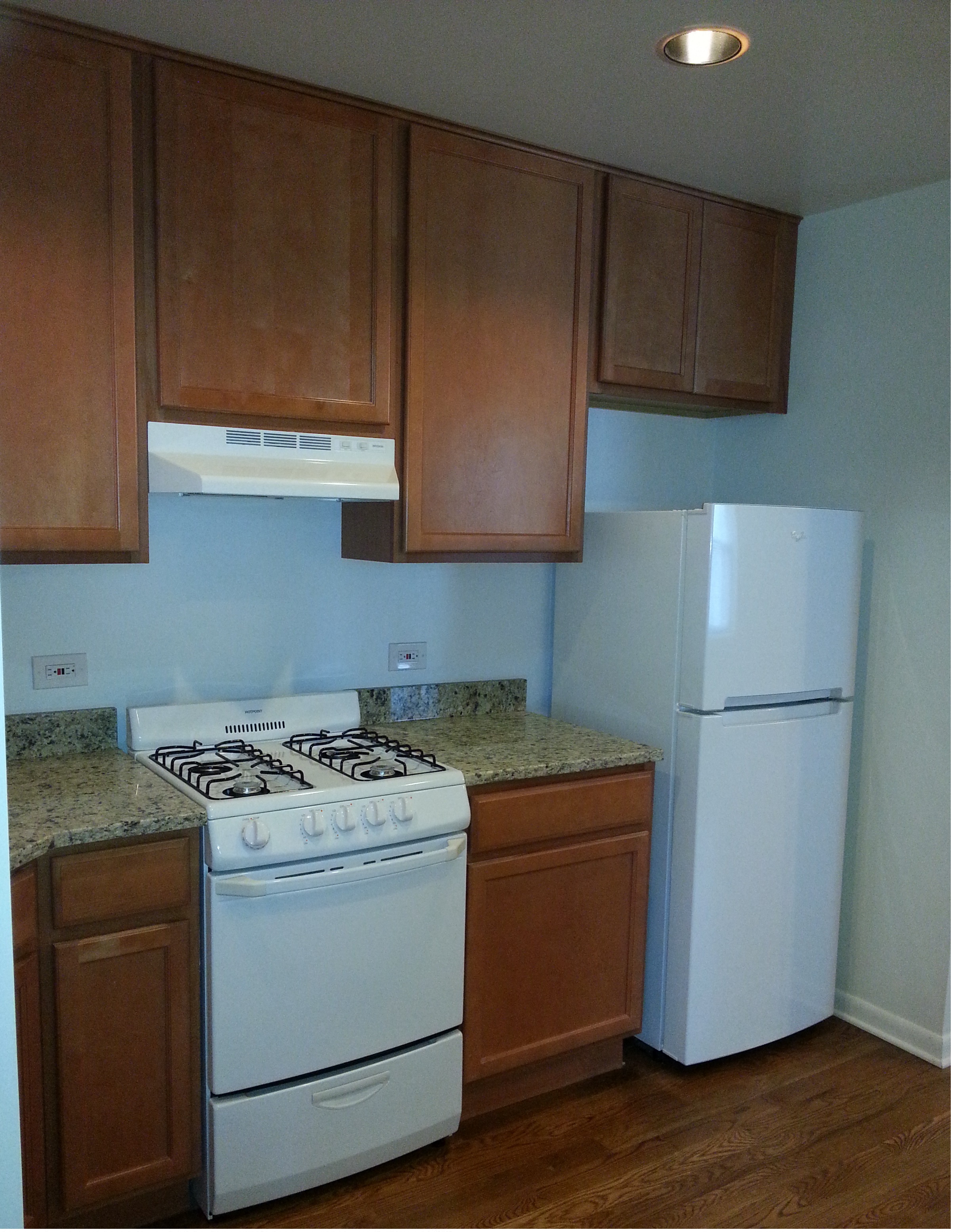 a kitchen with a stove and a refrigerator