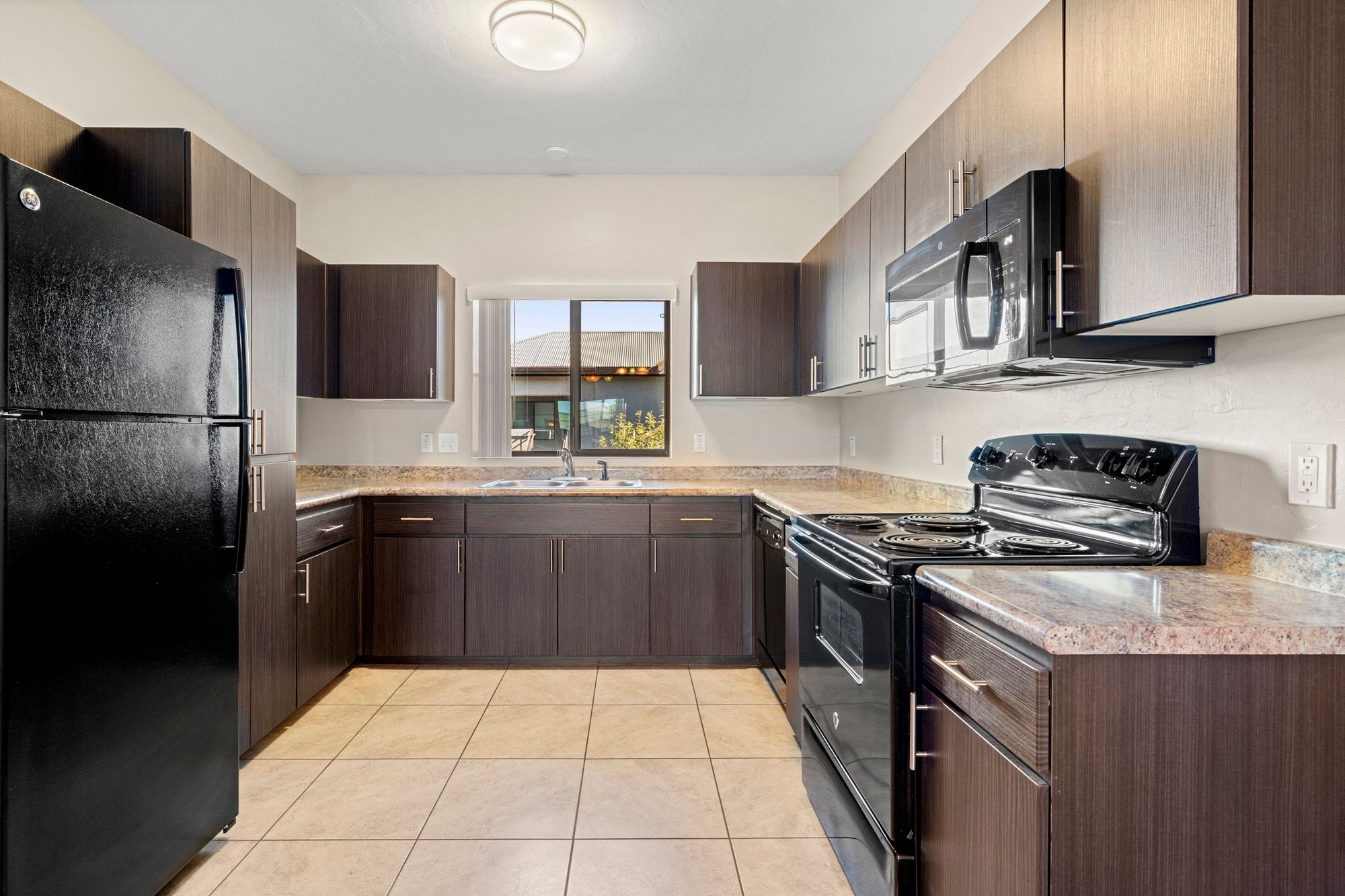 a kitchen with black appliances and granite counter tops