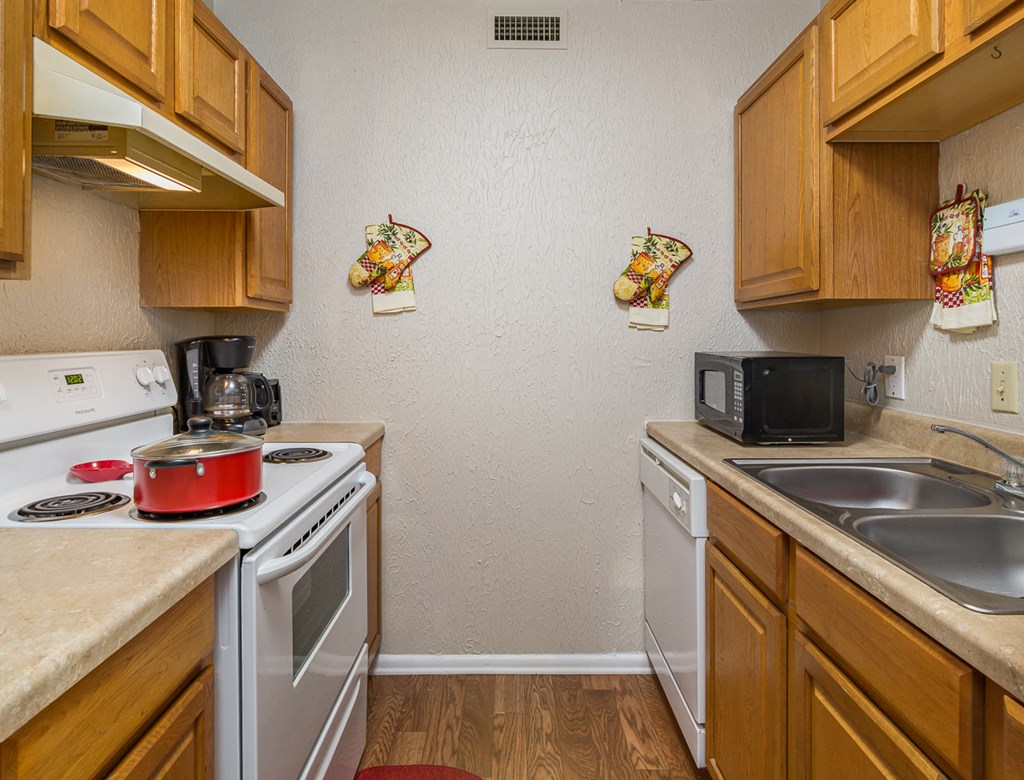 a kitchen with a stove microwave and sink