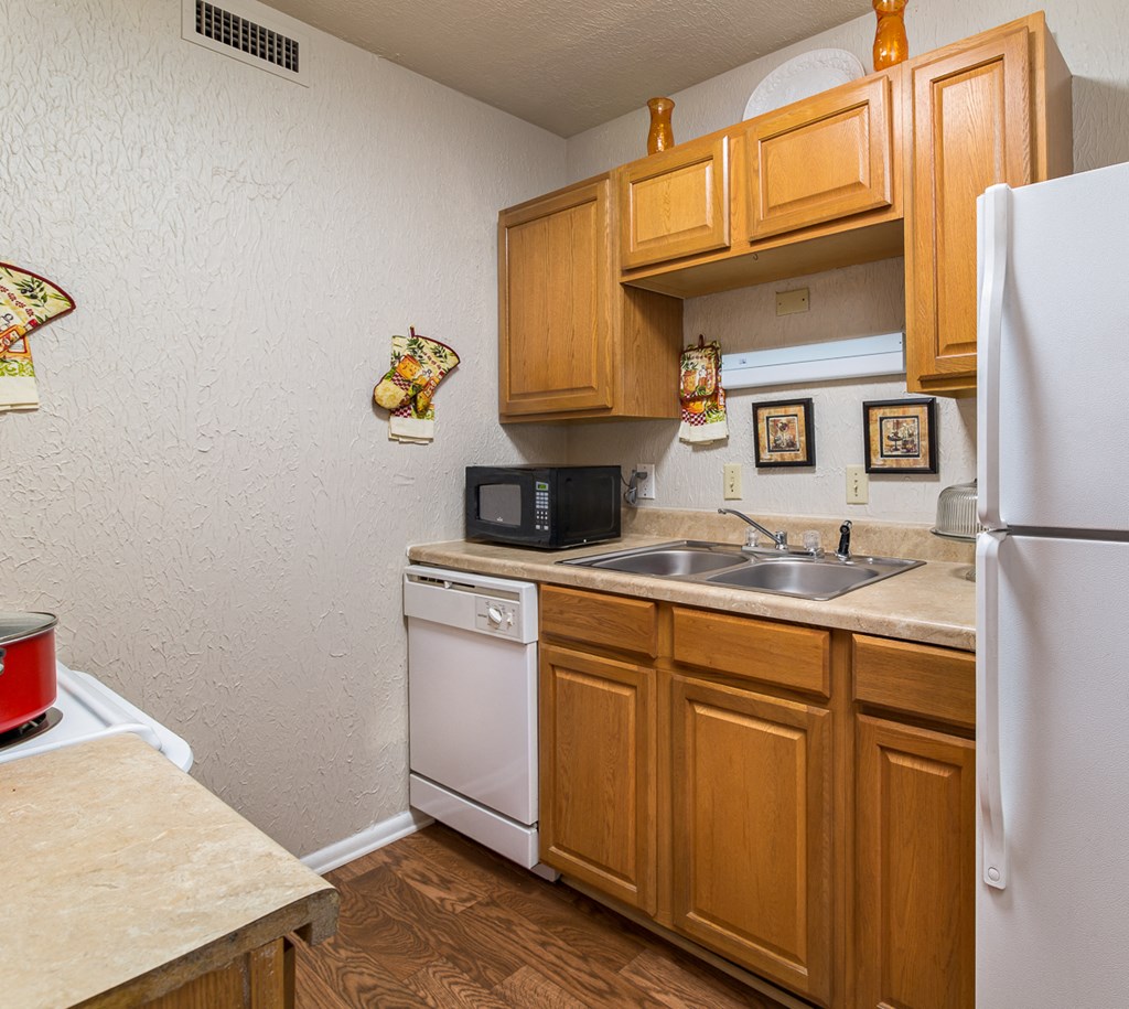 a kitchen with a sink and a refrigerator