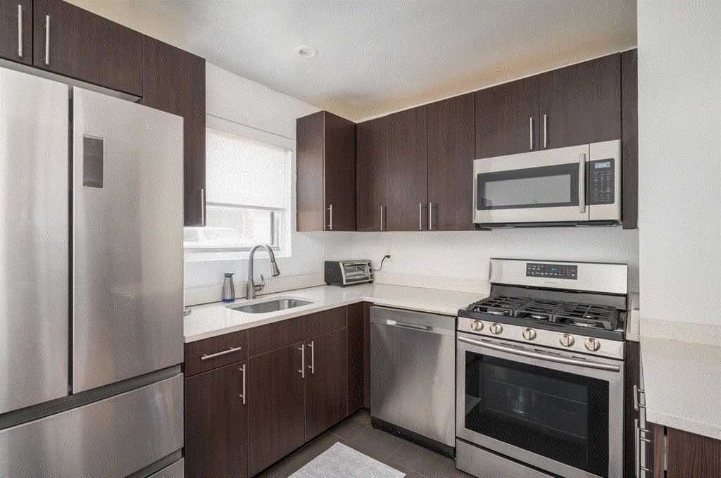 a kitchen with stainless steel appliances and wooden cabinets