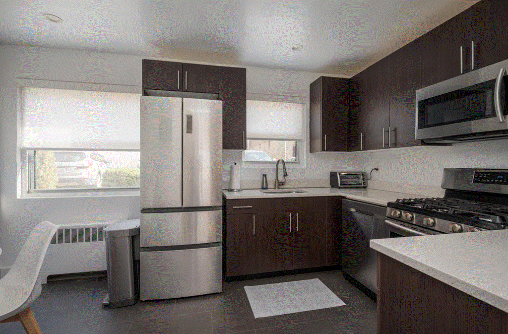 a kitchen with stainless steel appliances and wooden cabinets
