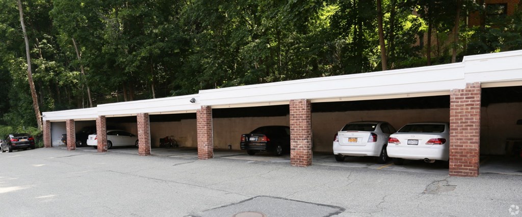 a car garage with three cars parked in it