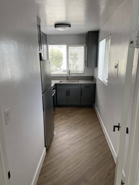 a kitchen with a sink and a refrigerator