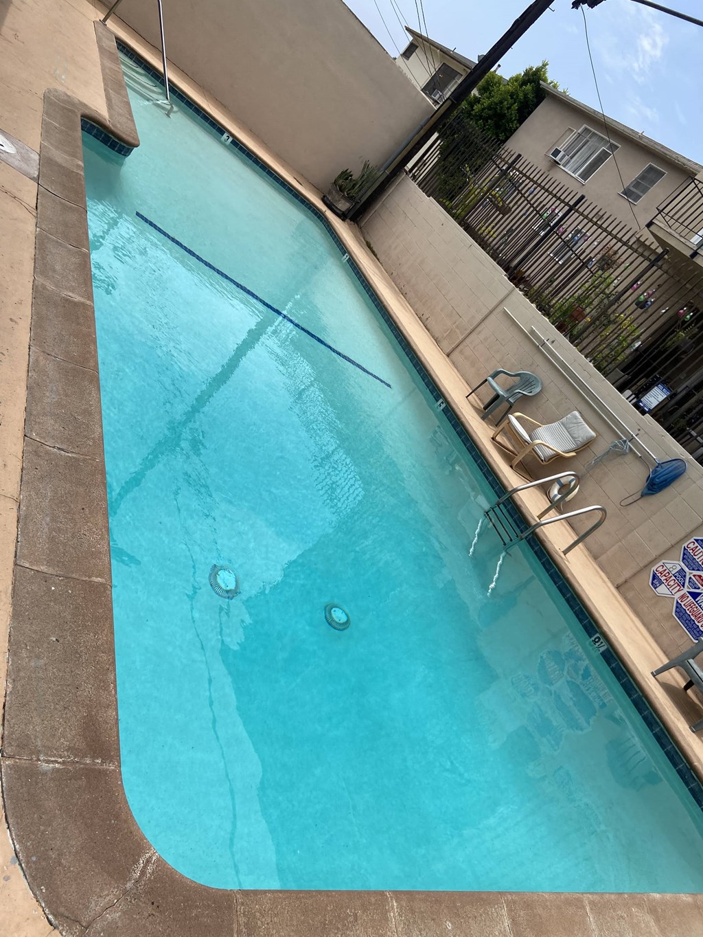 a large swimming pool in front of a building