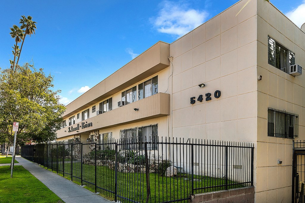 an office building with a fence in front of it