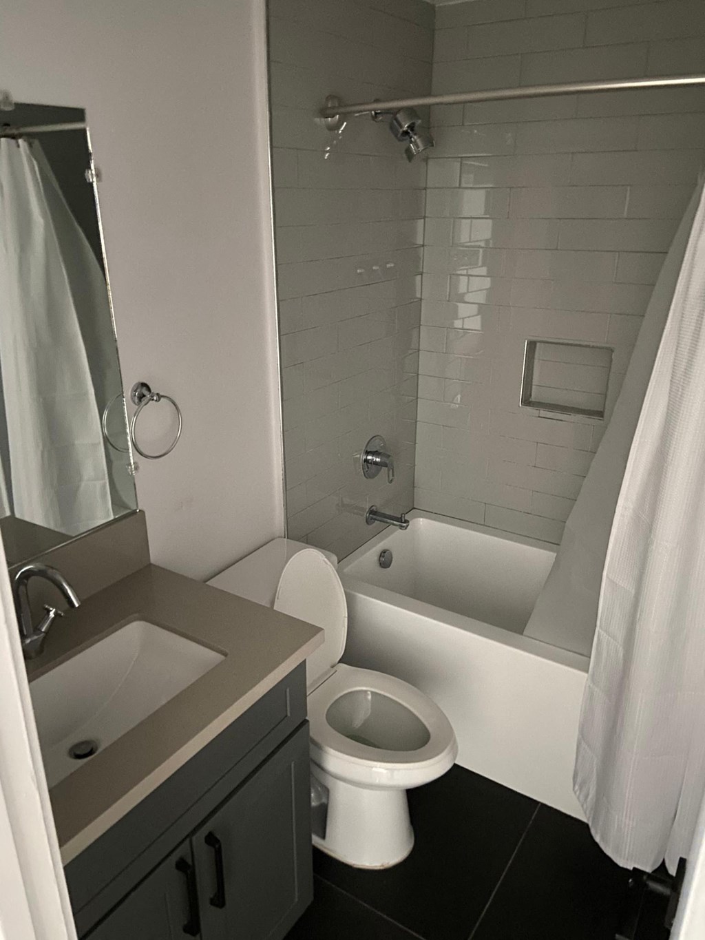 a bathroom with a toilet and a tub and a sink