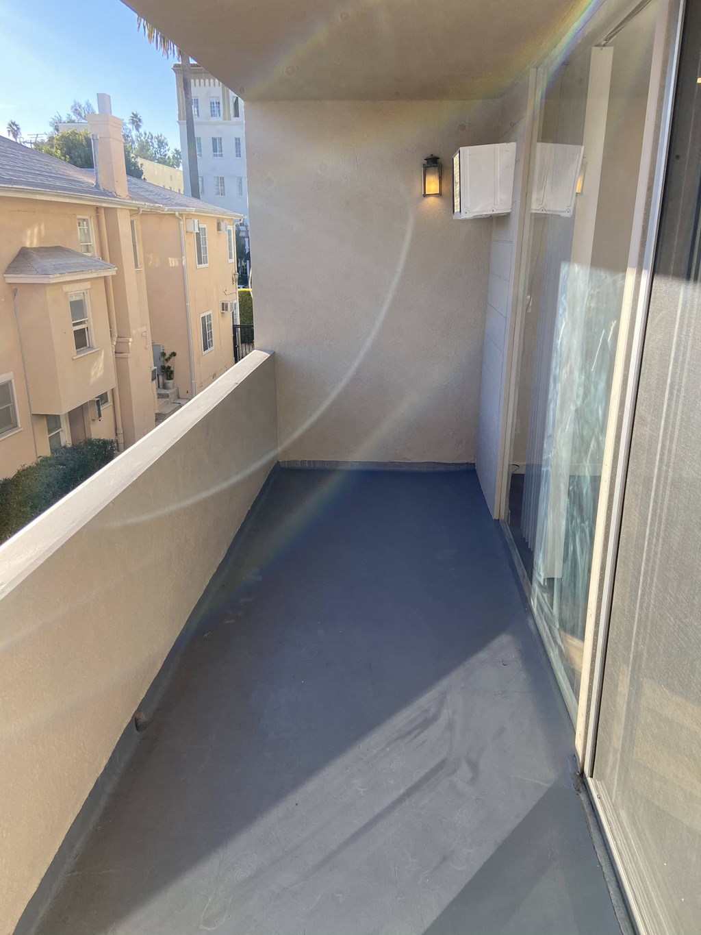 a room with a concrete floor and a balcony