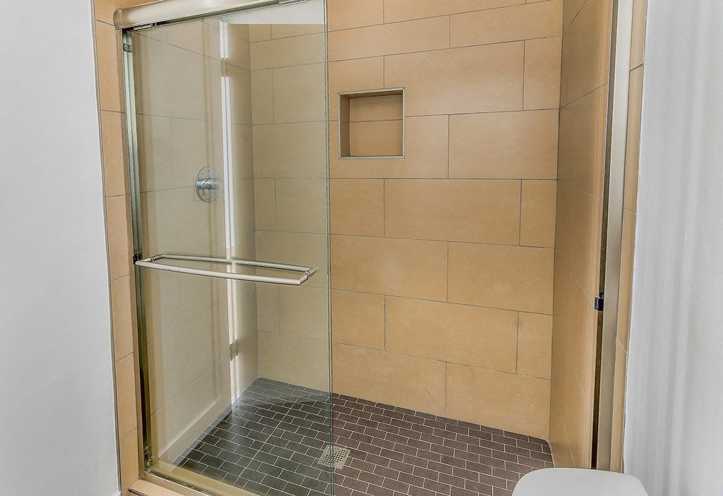 a bathroom with a shower and a toilet in it