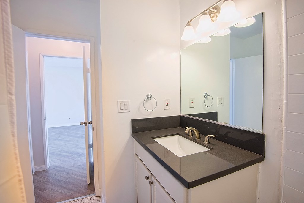 an empty bathroom with a sink and a mirror