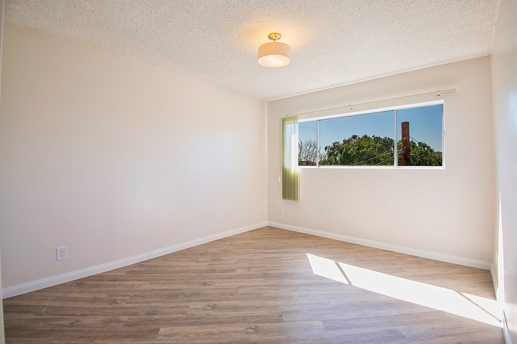an empty room with white walls and a window
