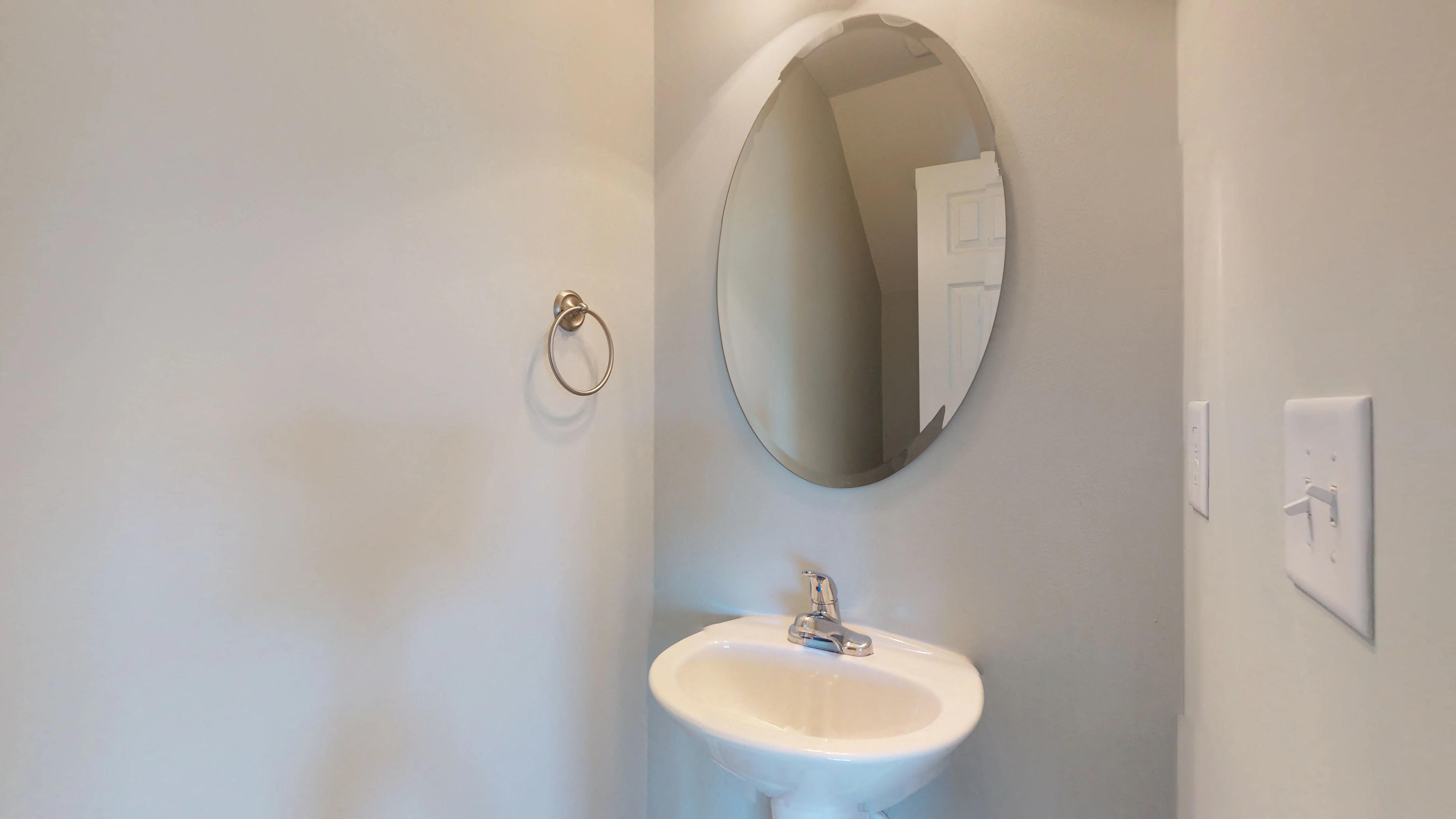 a small bathroom with a sink and a mirror