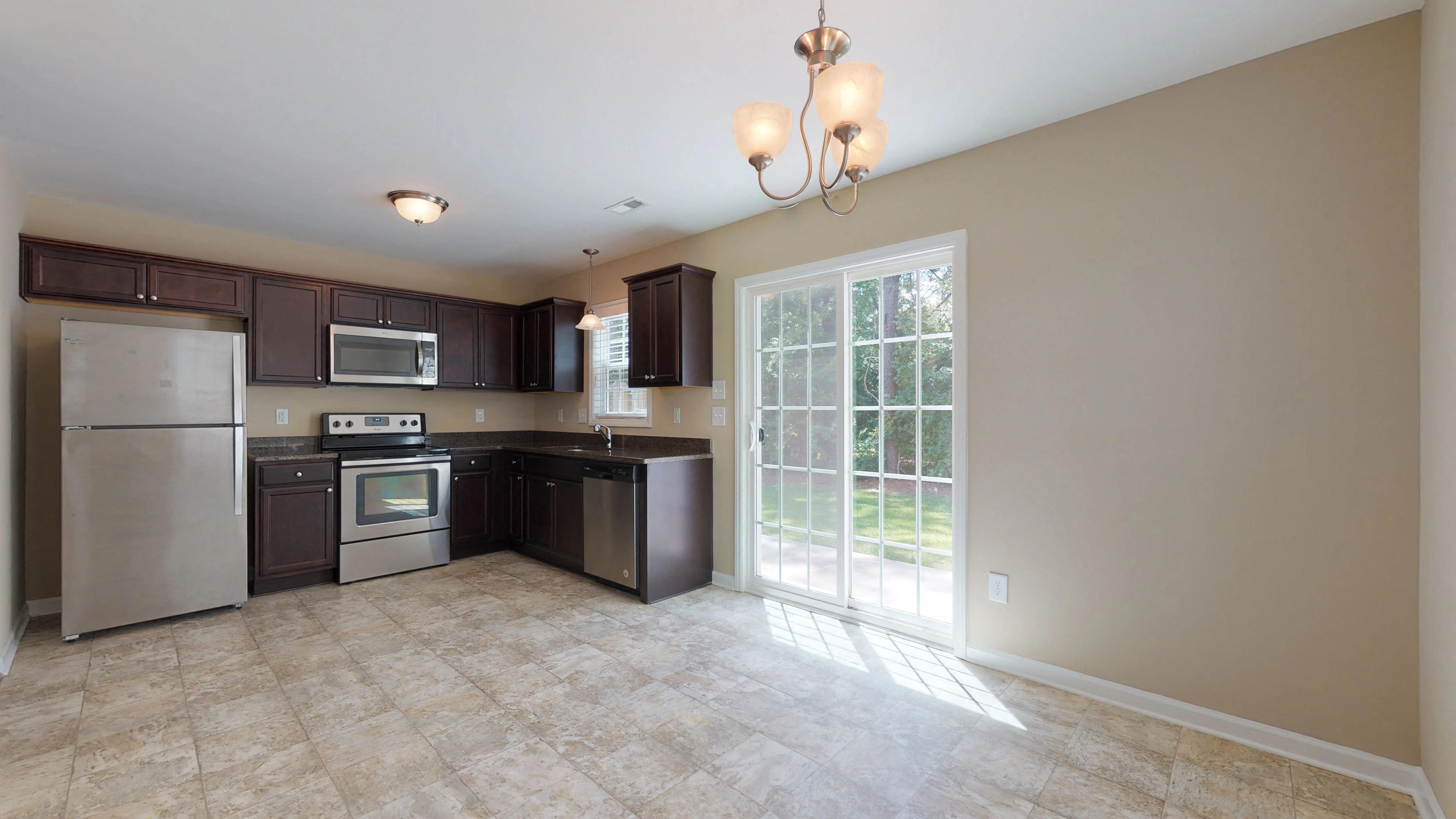 a kitchen with stainless steel appliances and a large window