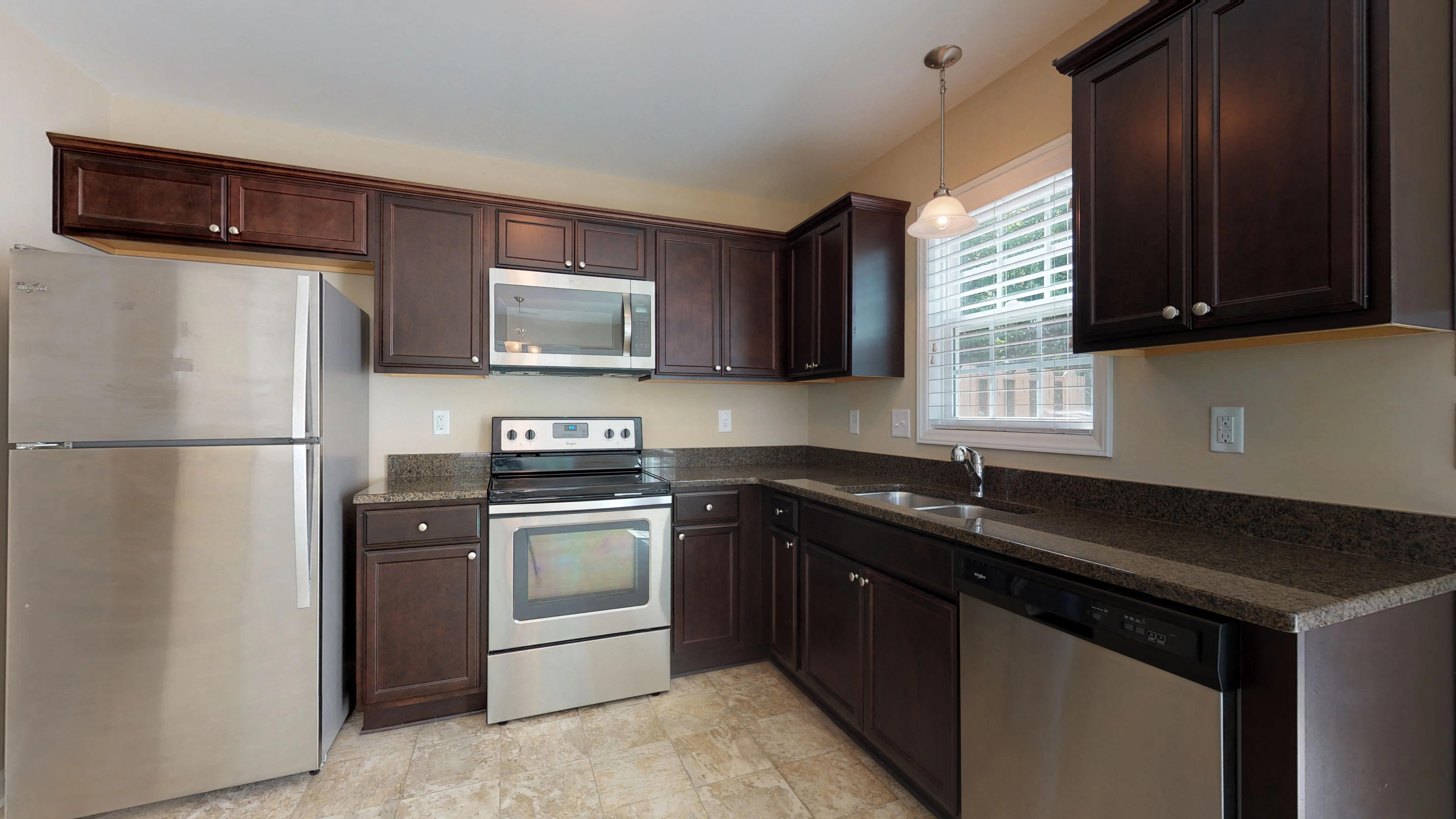 a kitchen with stainless steel appliances and a granite counter top