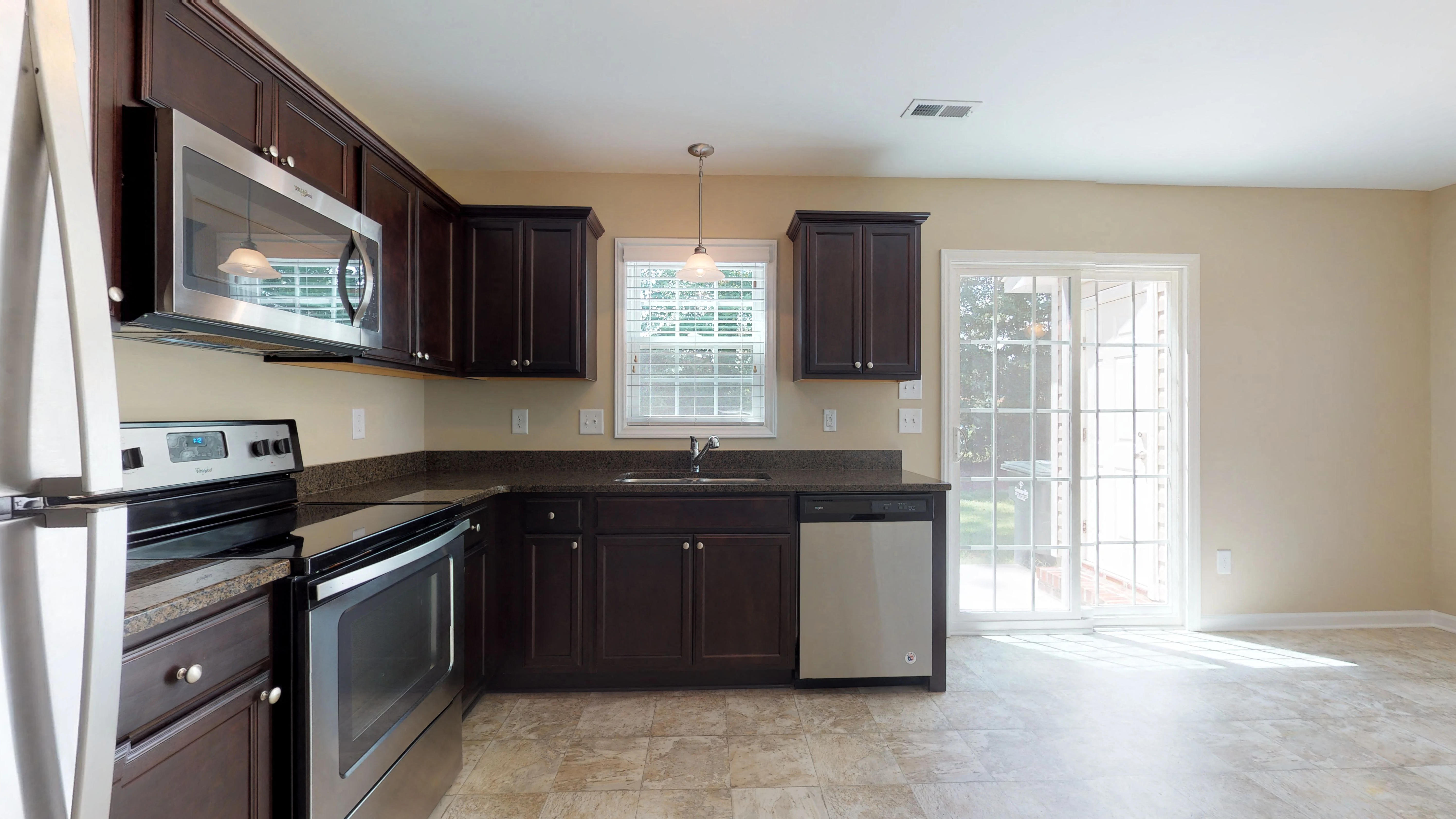 a kitchen with a sink and a stove and a window