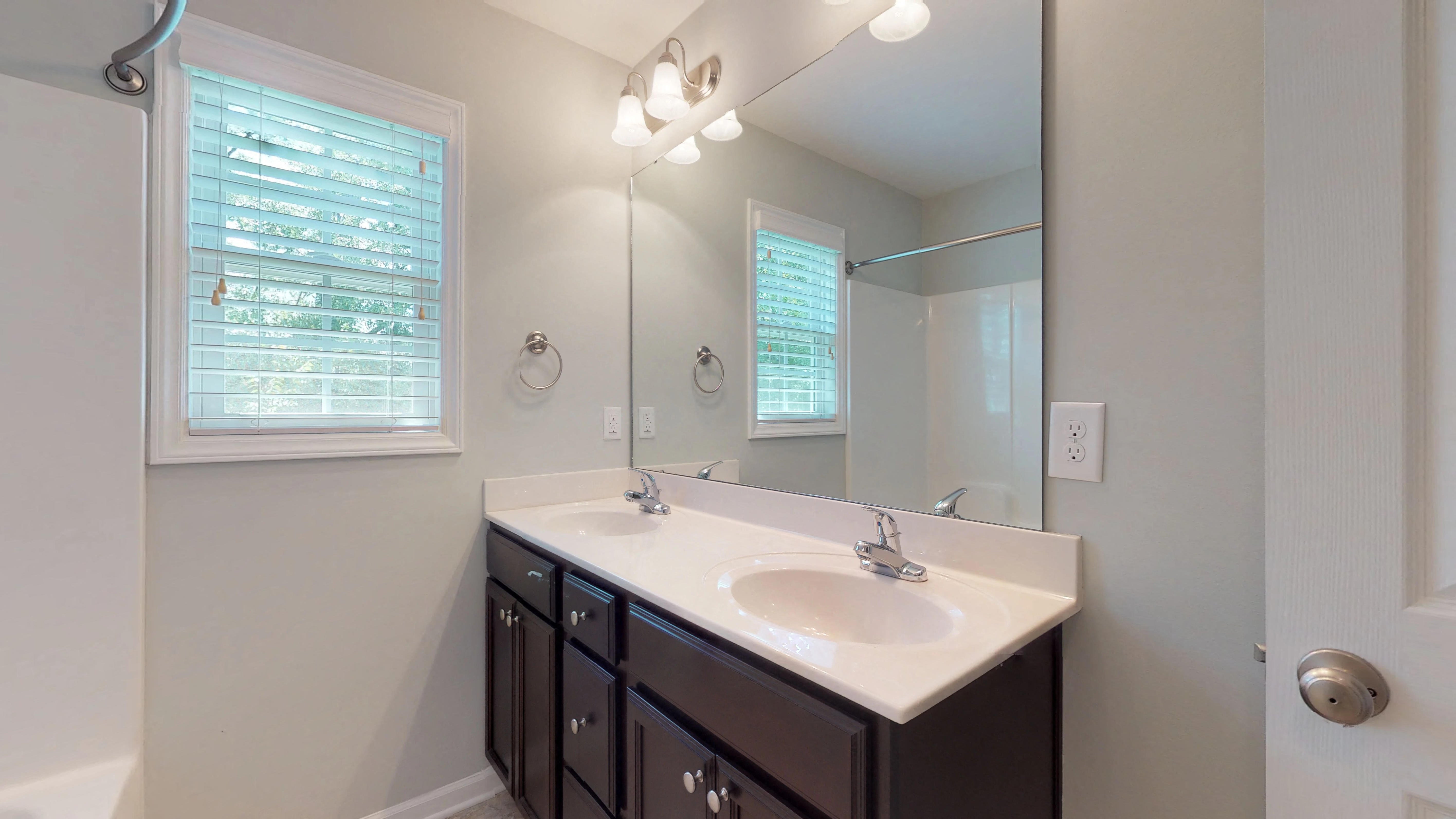 an empty bathroom with a sink and a mirror