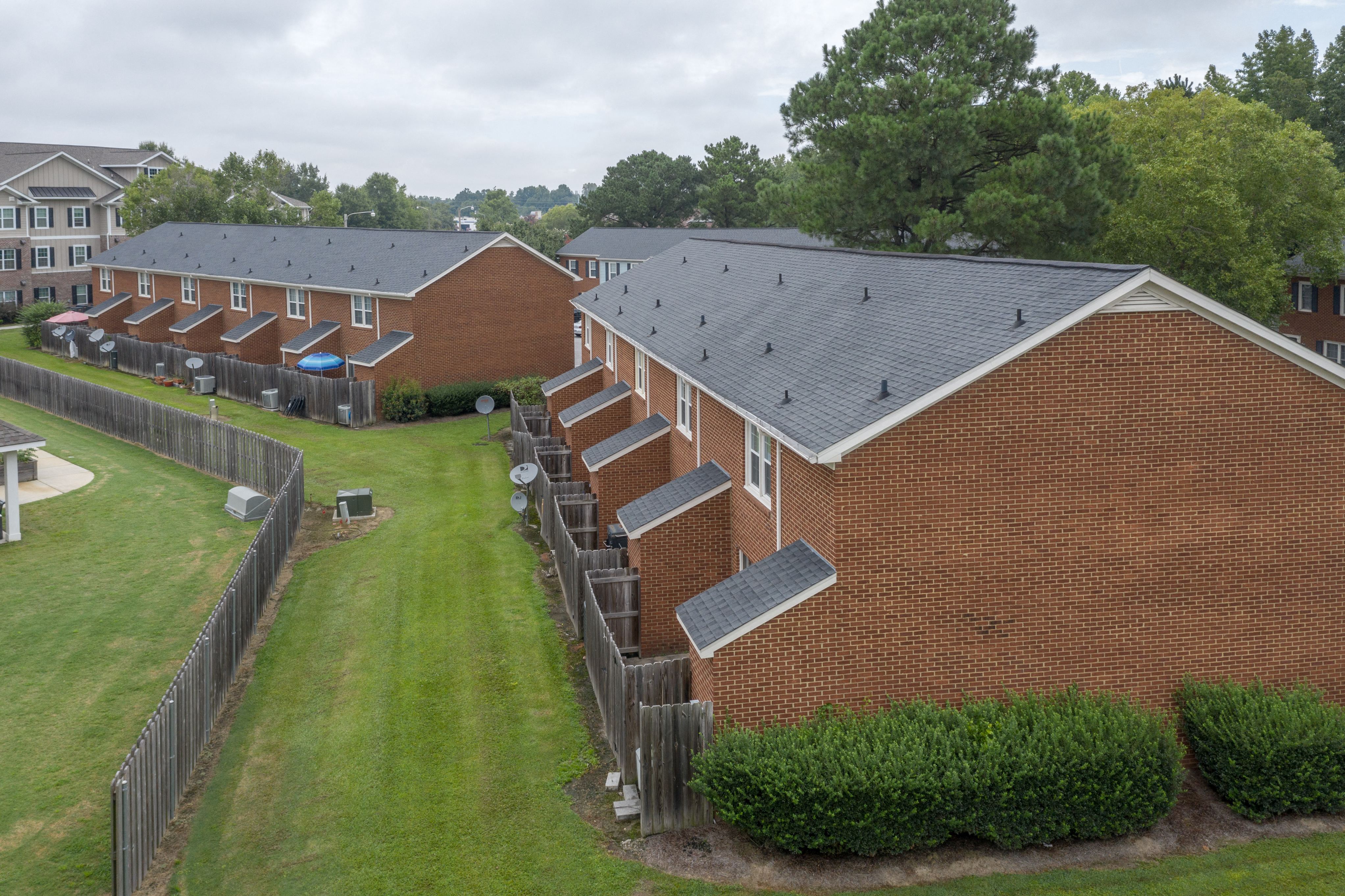 an aerial view of a row of houses with solar panels on the roofs