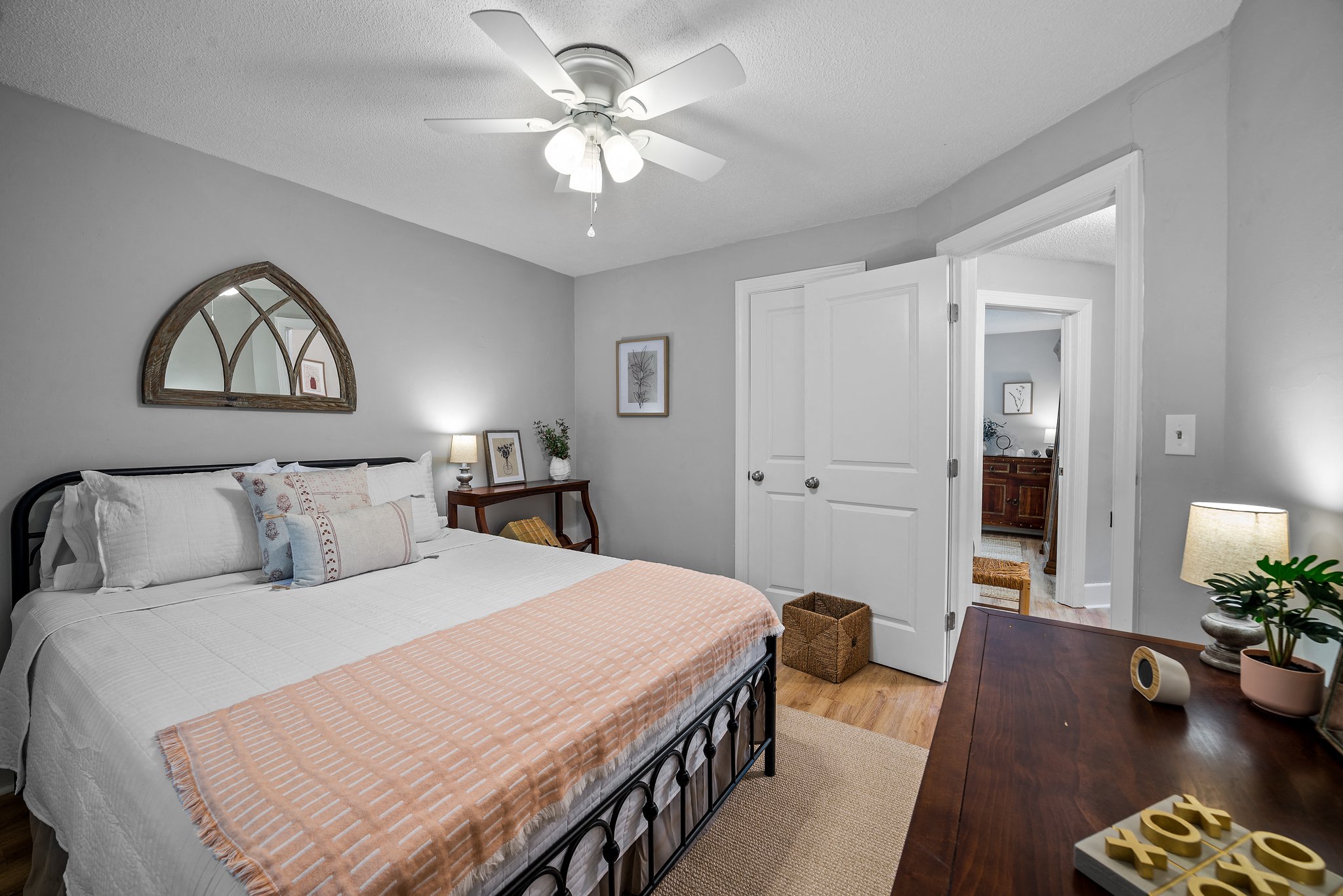 a bedroom with a large bed and a ceiling fan