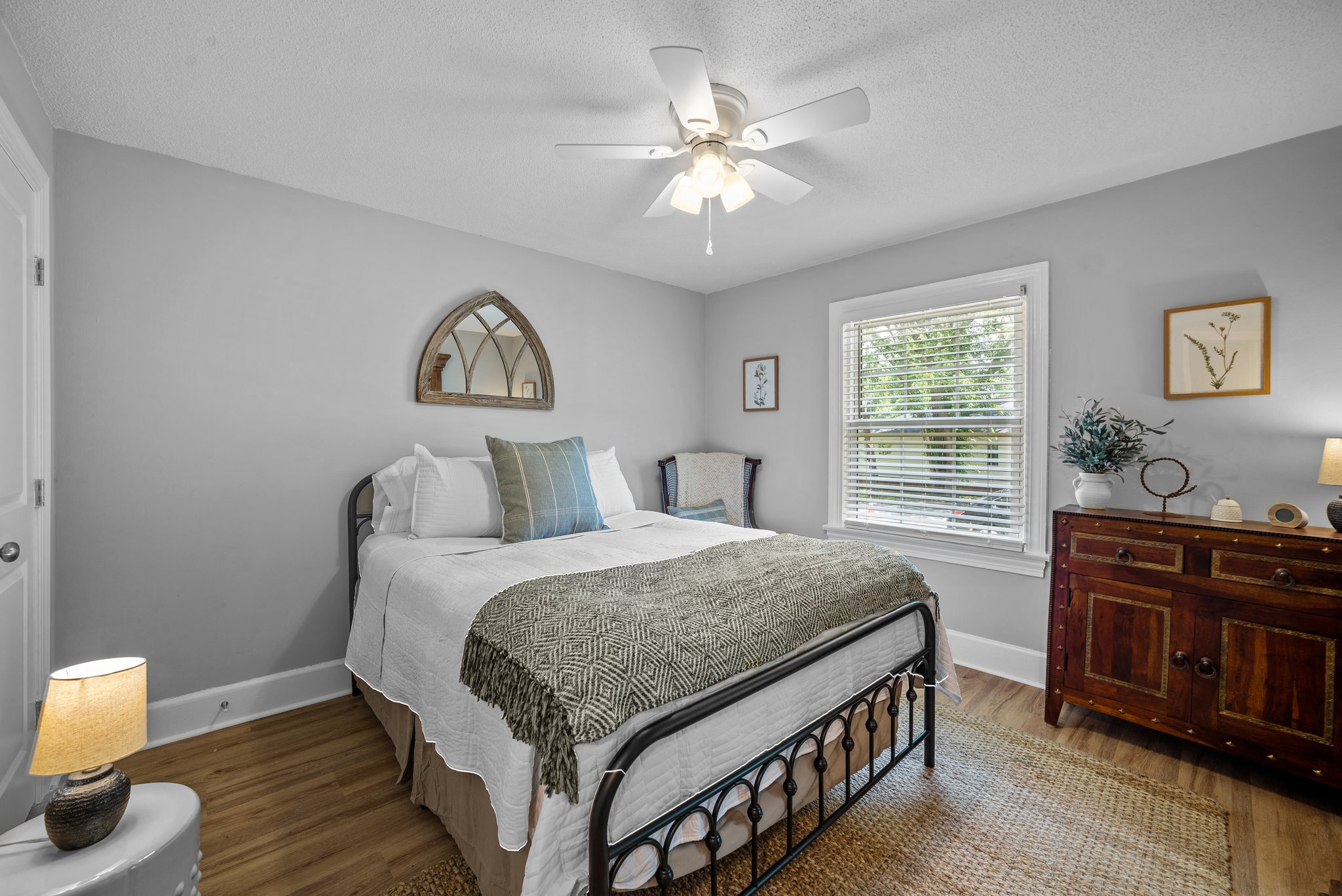 a bedroom with a bed and a ceiling fan