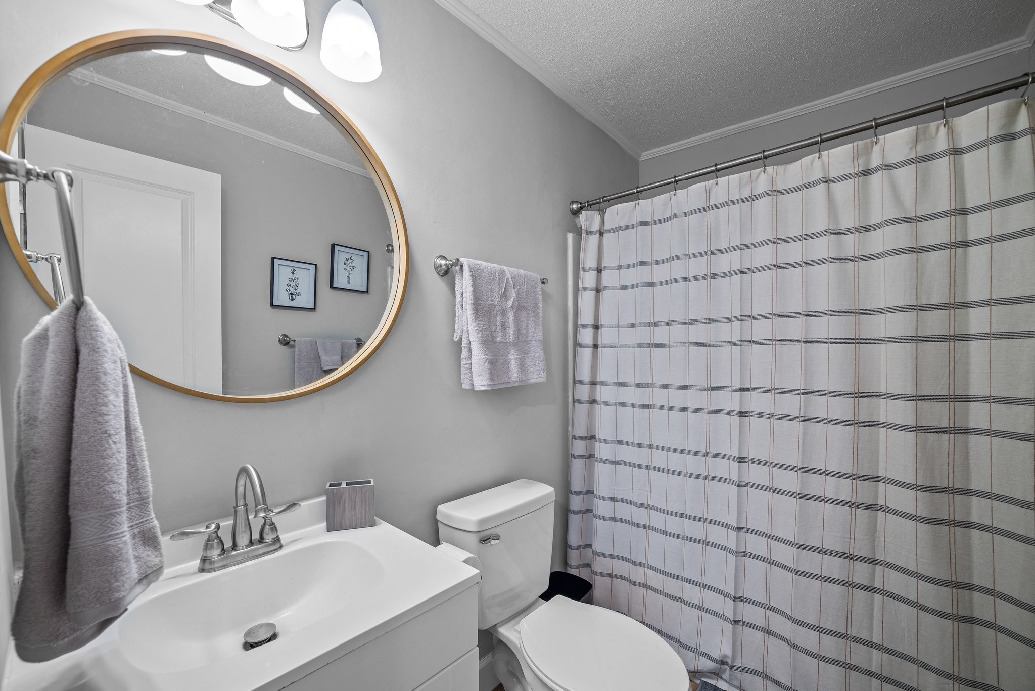 a bathroom with a shower and a sink and a toilet