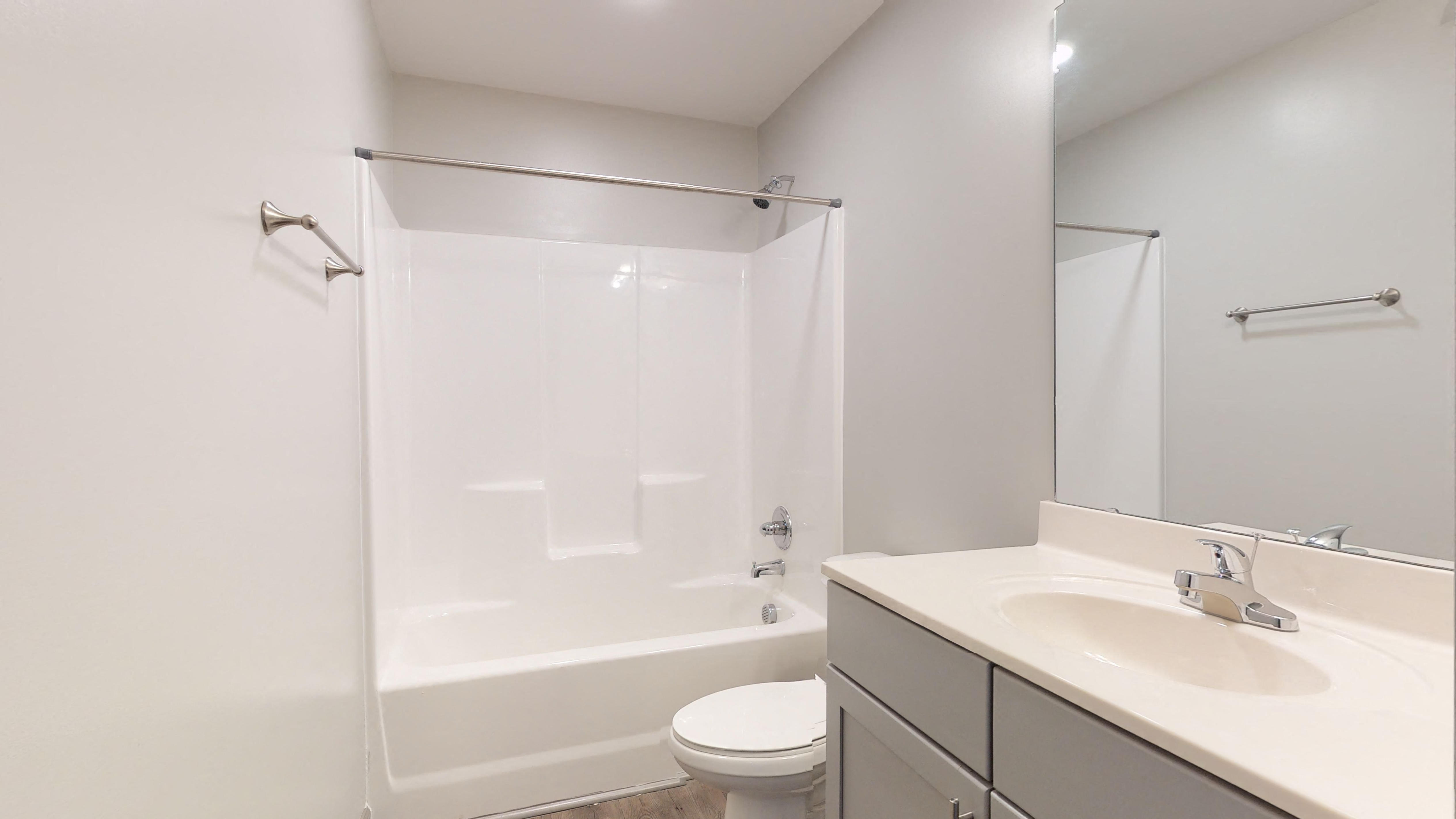 a bathroom with a shower and a sink and a toilet