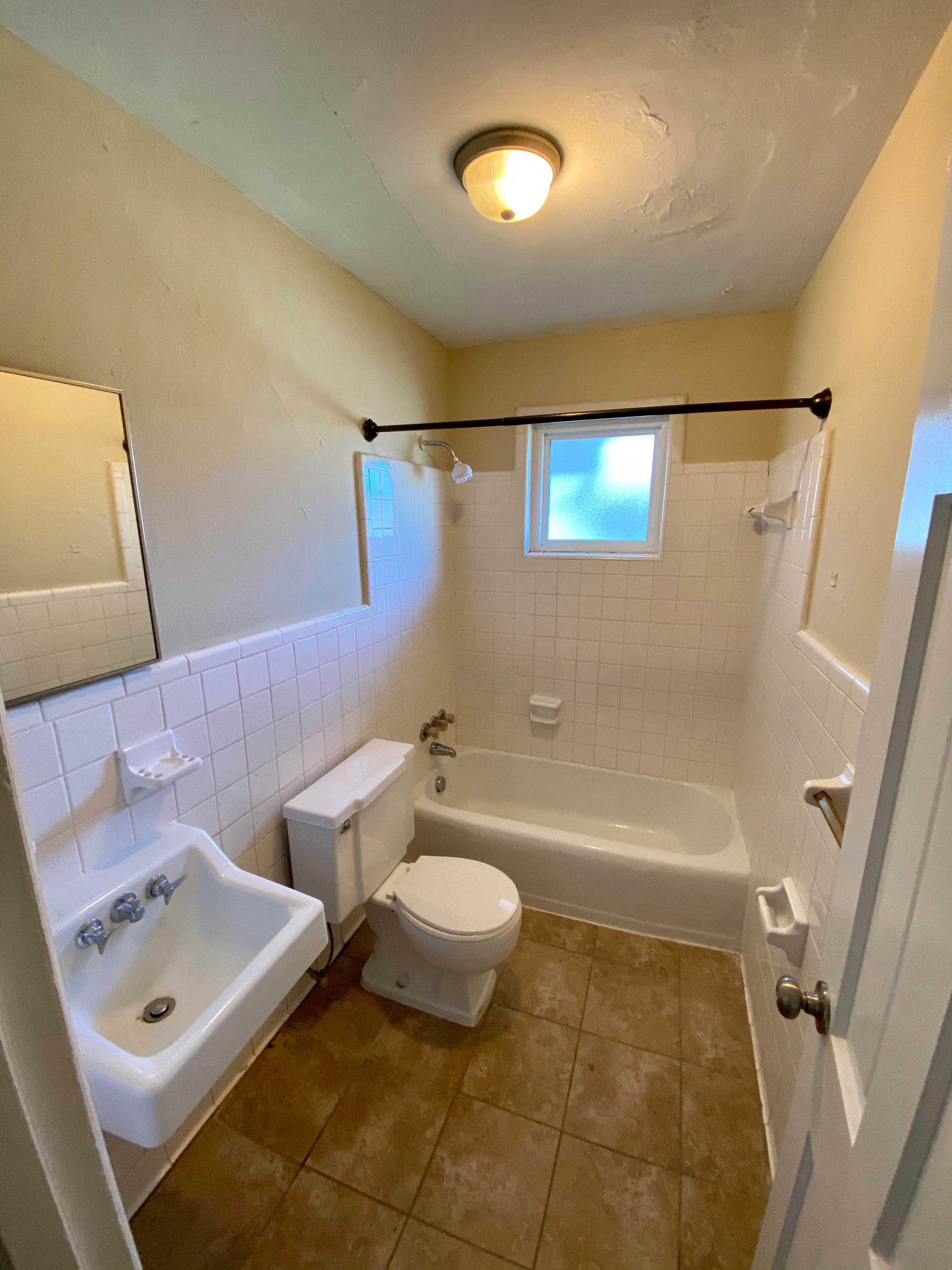 a bathroom with a toilet and a sink and a tub