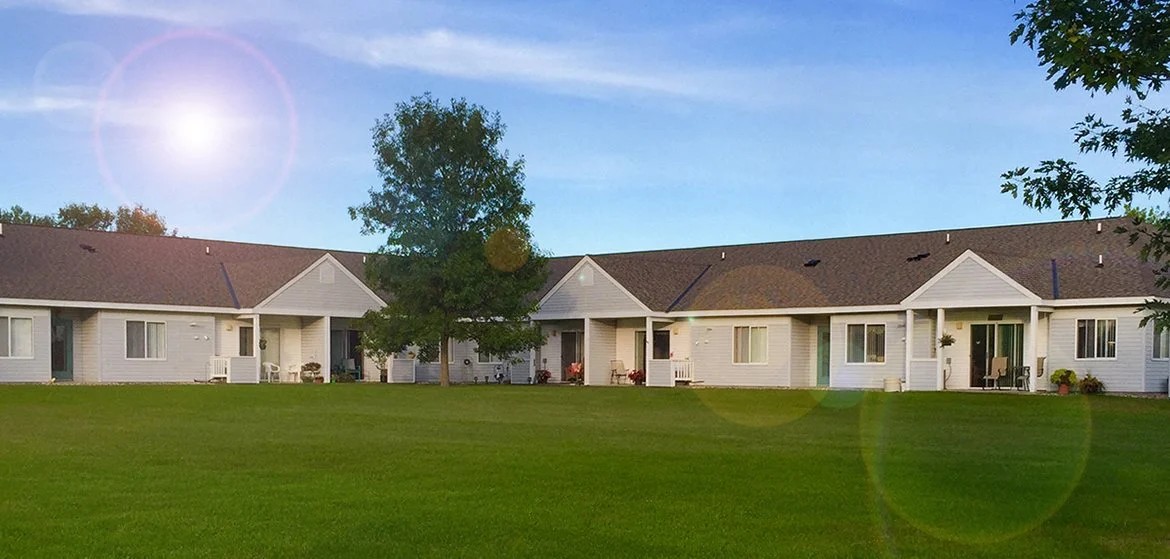 A sunny day at a residential area with houses and green lawns.
