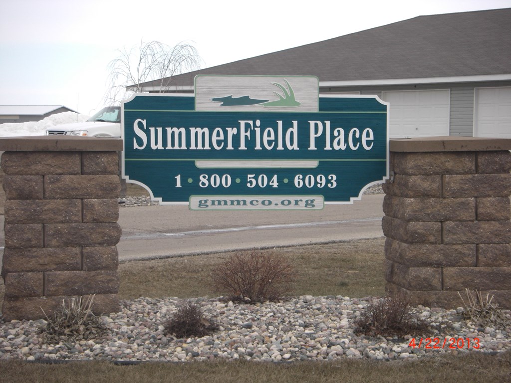 a sign for summerfield place in front of a house