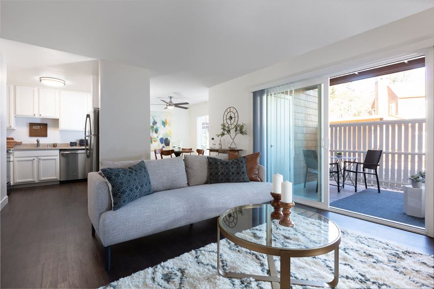 a living room with a couch and a glass coffee table
