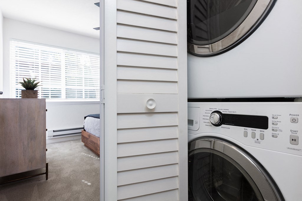 a washer and dryer in a laundry room with a window