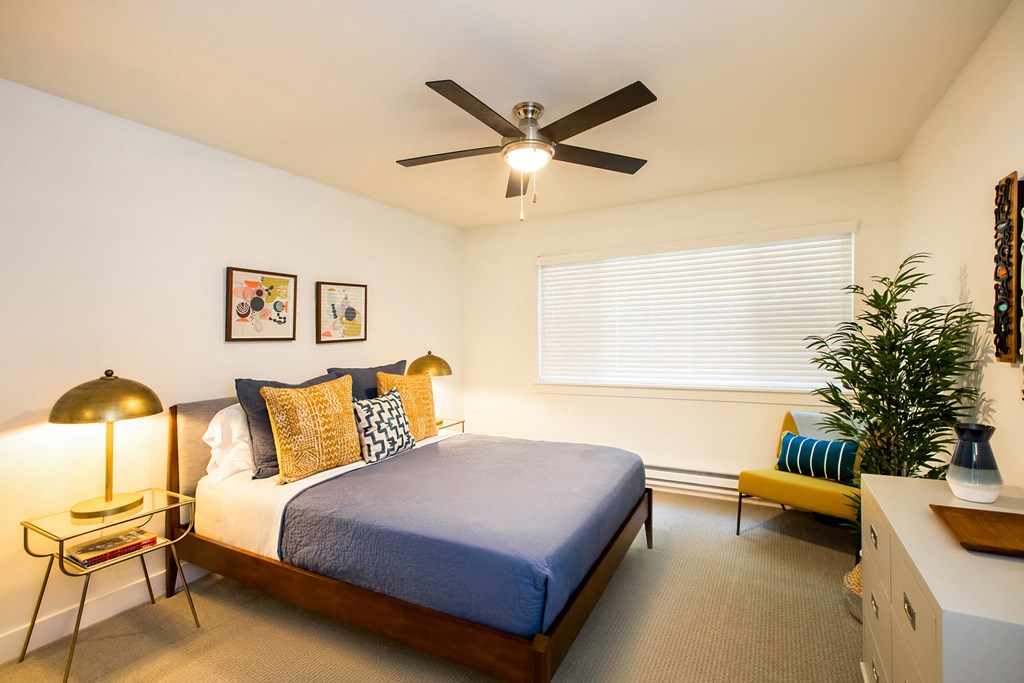 a bedroom with a bed and a ceiling fan