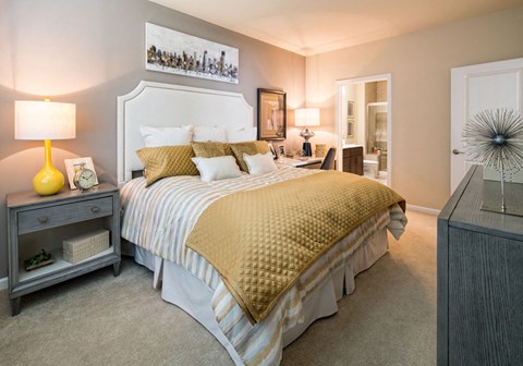 a bedroom with a bed and a night stand with lamps