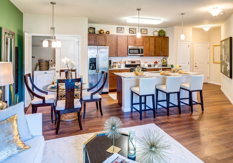 a kitchen and dining room with a table and chairs in a house