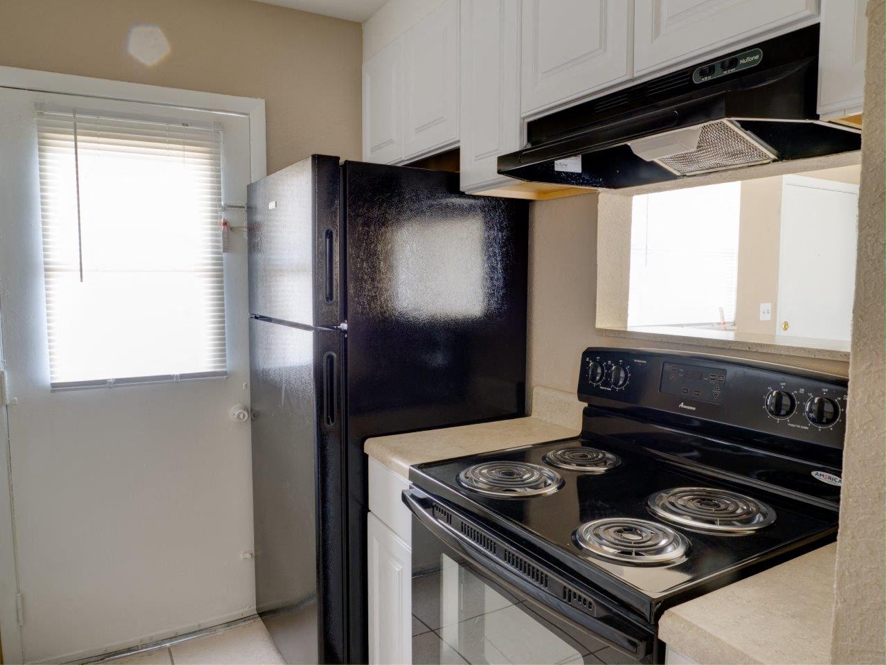 Updated Kitchen With Black Appliances at Hibiscus Place Apartments, Orlando, 32808