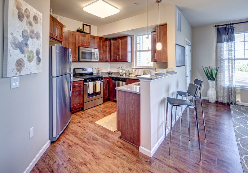 a kitchen with stainless steel appliances and wooden cabinets