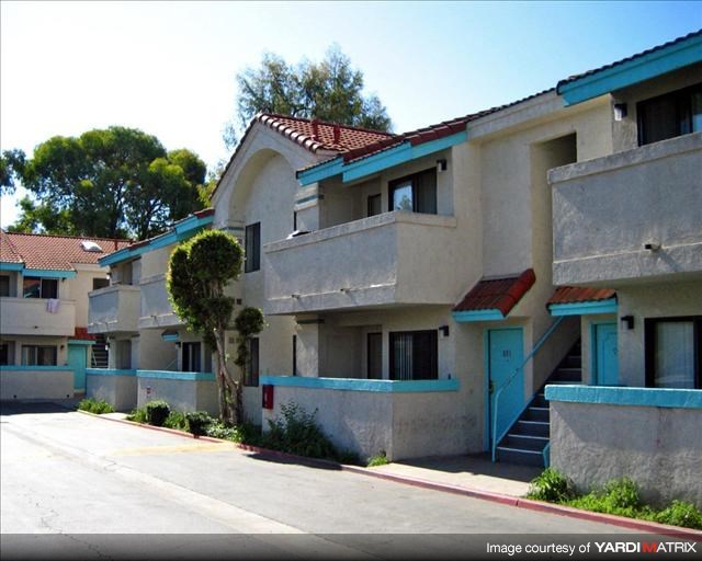 an apartment building with blue and white walls and stairs