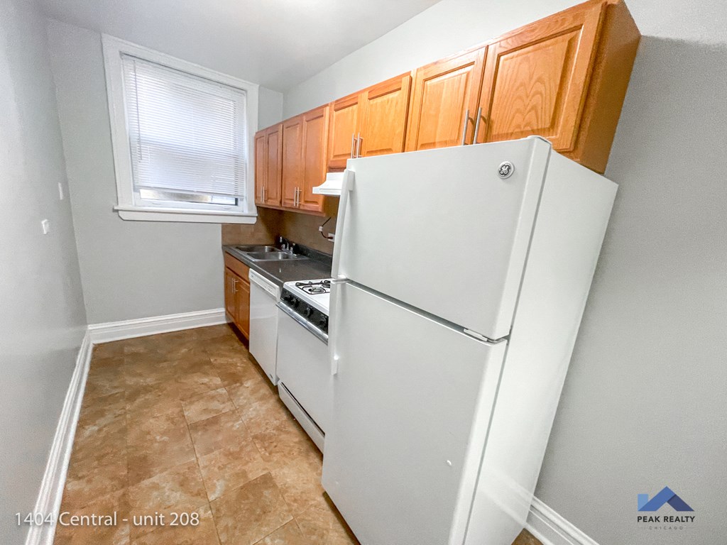 a kitchen with white appliances and wooden cabinets