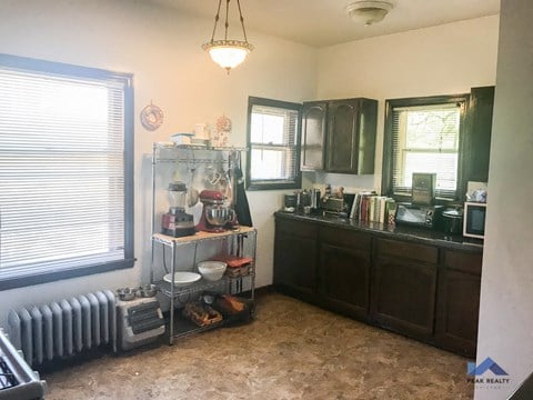 a kitchen with a radiator and a counter and a window