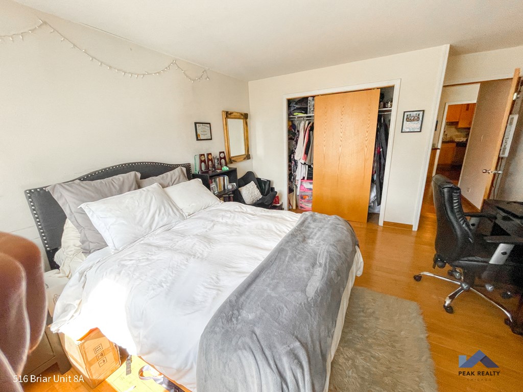 a bedroom with a bed and a desk and a chair