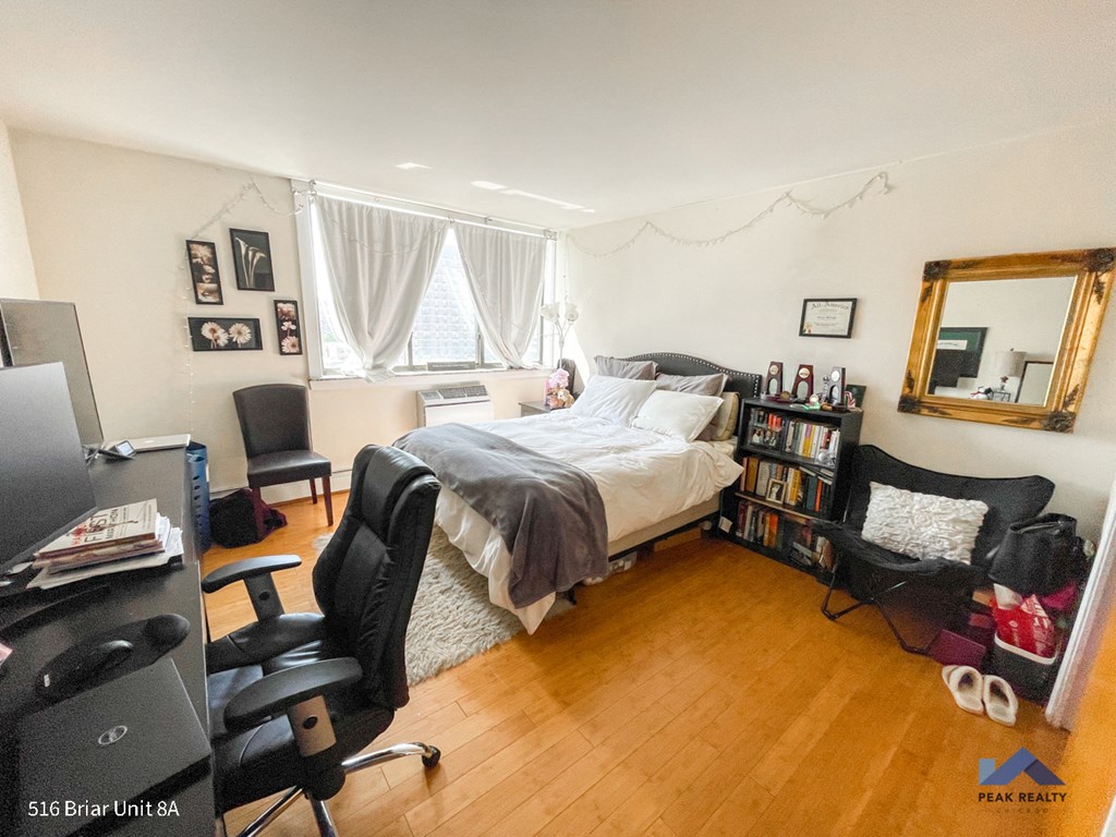a bedroom with a bed and a desk and a tv