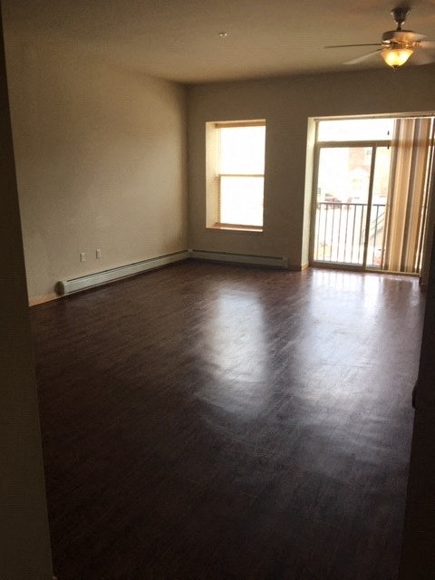 an empty living room with a hard wood floor