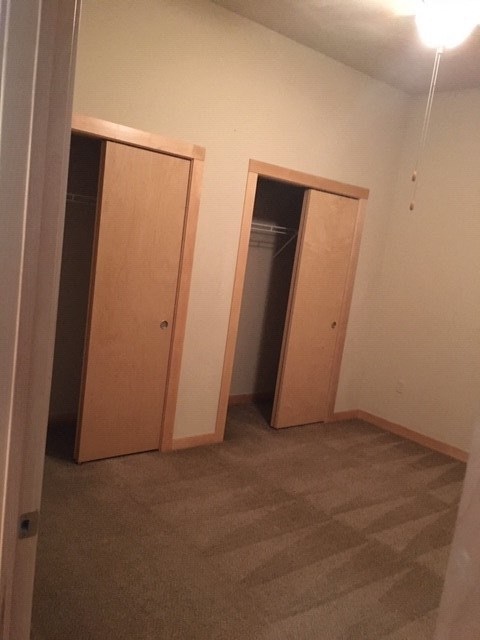an empty room with three doors in it