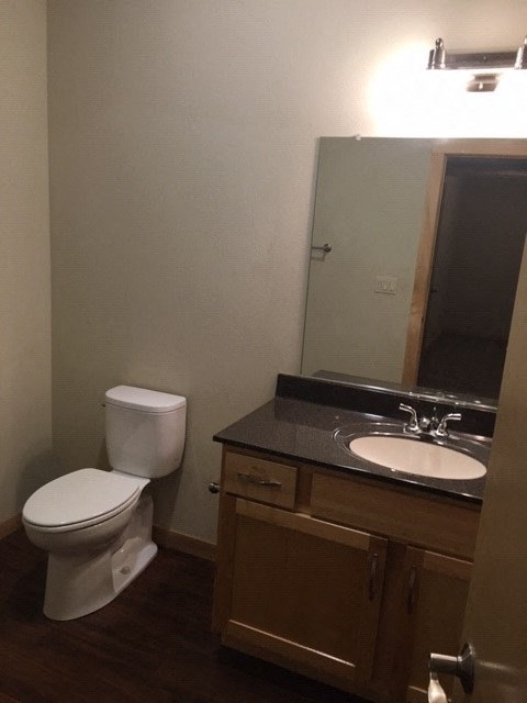 a bathroom with a toilet and a sink and a mirror