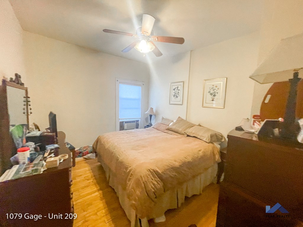 a bedroom with a bed and a ceiling fan