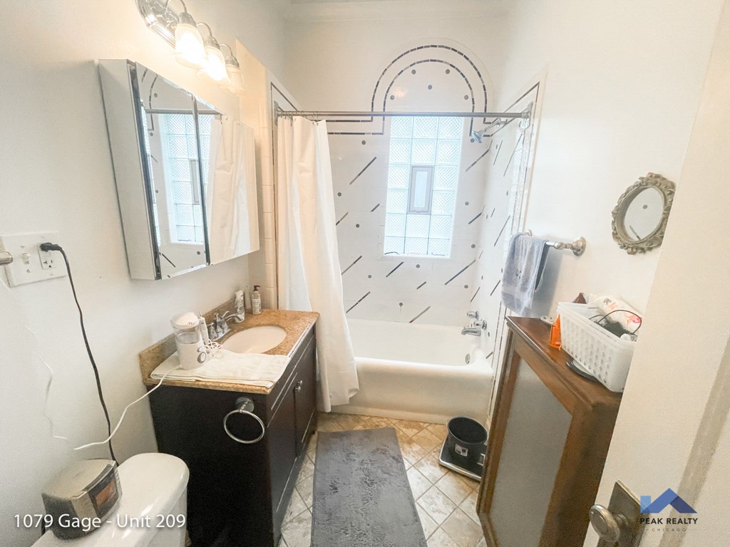 a bathroom with a shower and a sink and a mirror