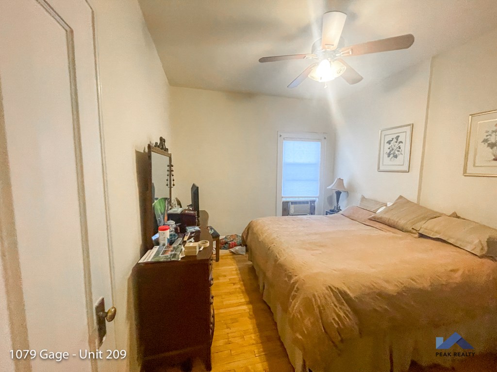 a bedroom with a bed and a ceiling fan